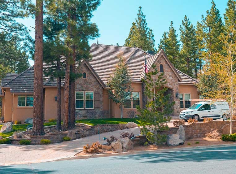Exterior shot of a large house in the woods